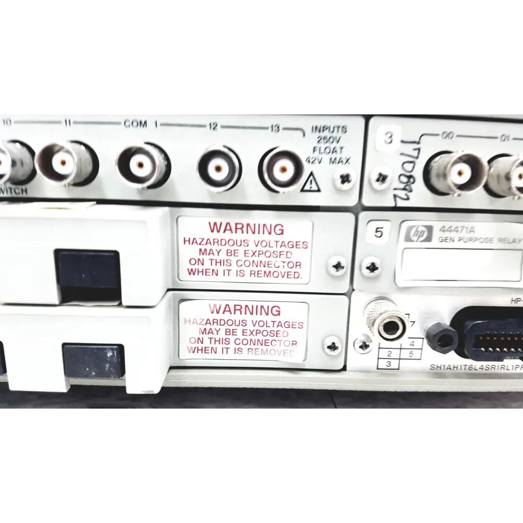 White hp 44471a general-purpose relay panel with labeled inputs and warnings on the back of hewlett packard 3488a switch control unit