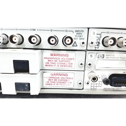 White hp 44471a general-purpose relay panel with labeled inputs and warnings on the back of hewlett packard 3488a switch control unit