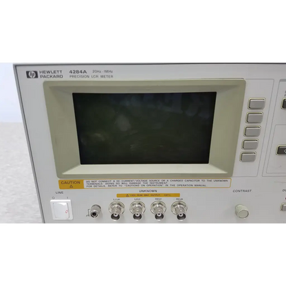 White hewlett packard 4284a precision lcr meter with black screen and silver bnc connectors for precise measurements