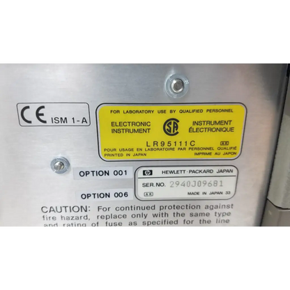 Silver metallic hewlett packard 4284a precision lcr meter with yellow warning label and black text model lr95111c