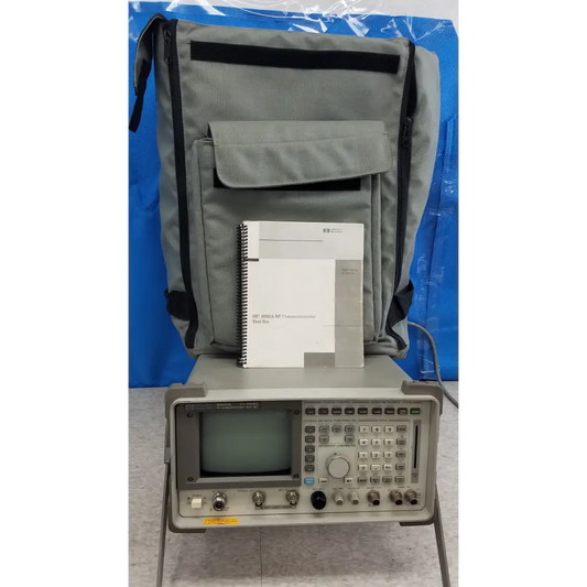 Gray tektronix oscilloscope with small screen, buttons, knobs, and ports in hewlett packard communications test set