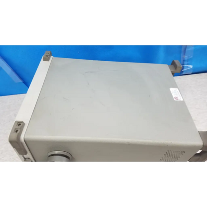 Gray metallic hewlett packard communications test set with rounded corners and ventilation grilles for rf testing