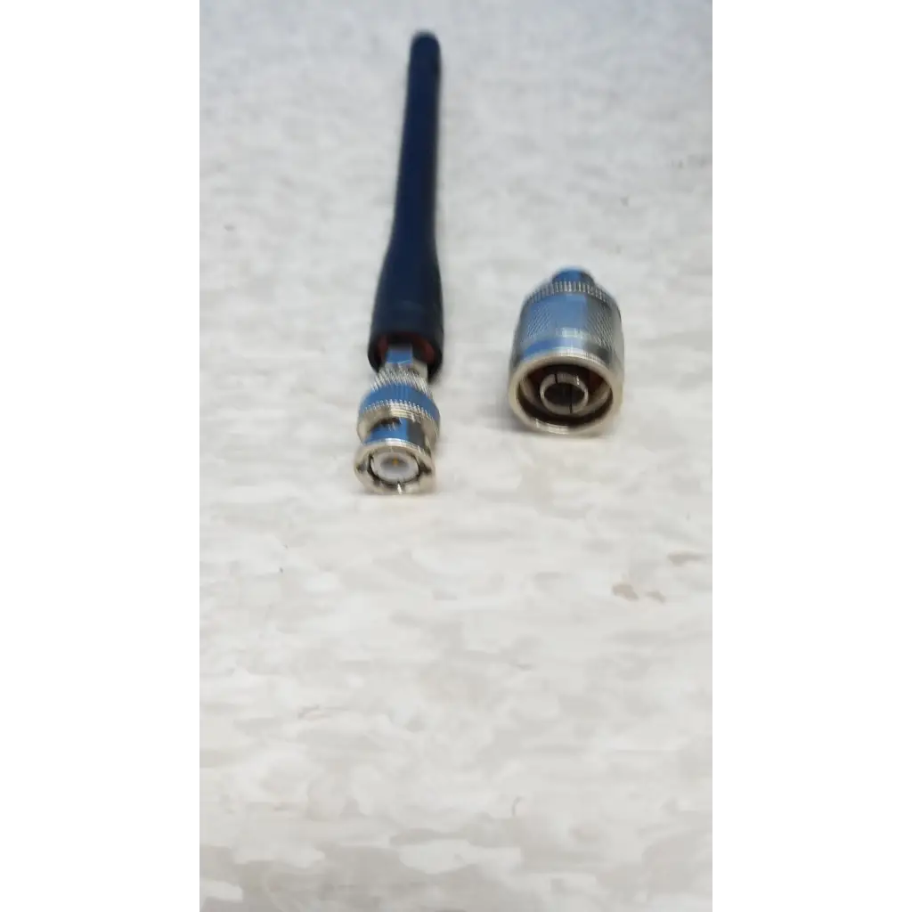Blue antenna with metallic connector and silver bnc plug on hewlett packard 8920a communications test set