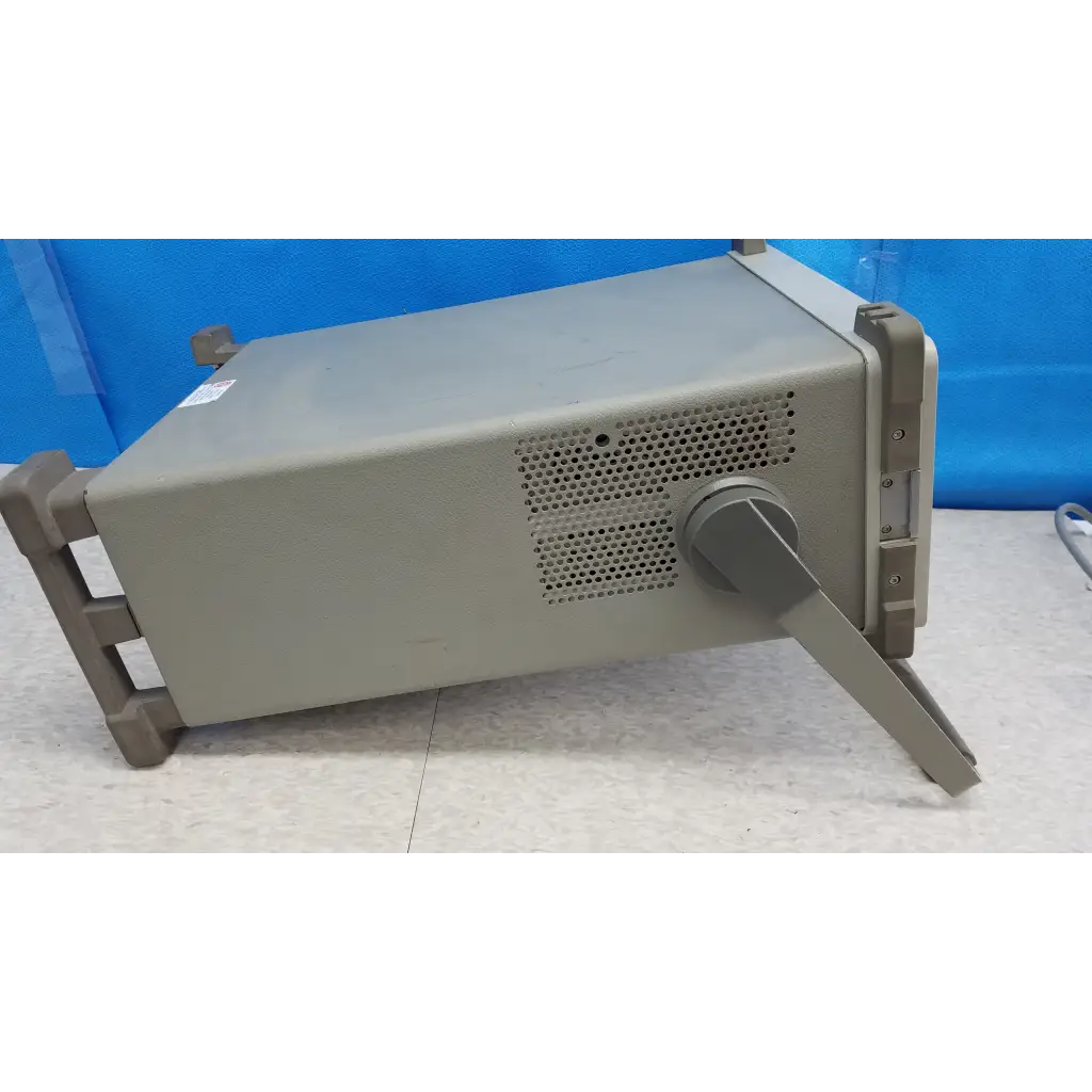 Gray metallic hewlett packard 8920a communications test set with perforated ventilation panel and integrated handle