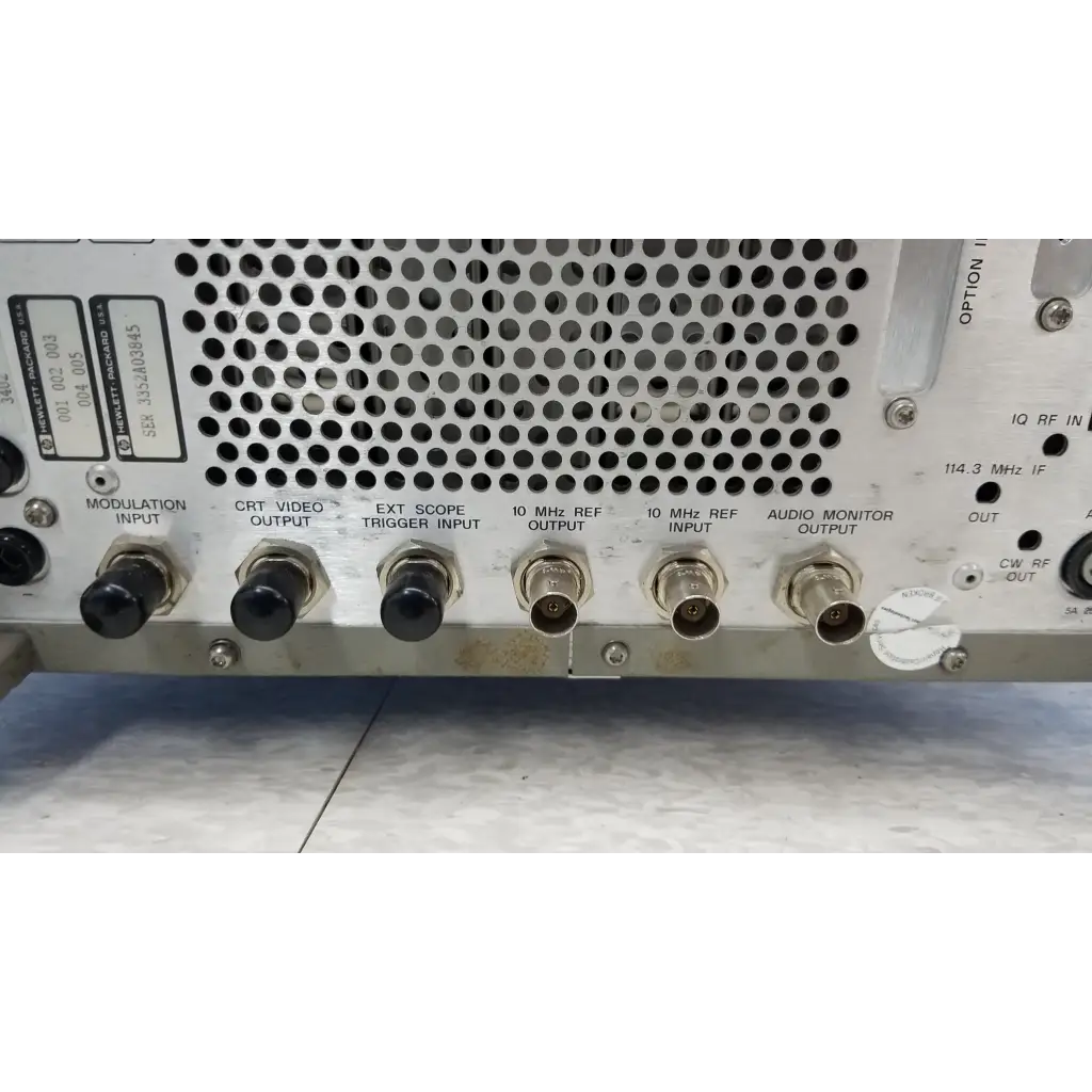 Rear panel of silver metallic hewlett packard 8920a communications test set with bnc connectors and ventilation holes