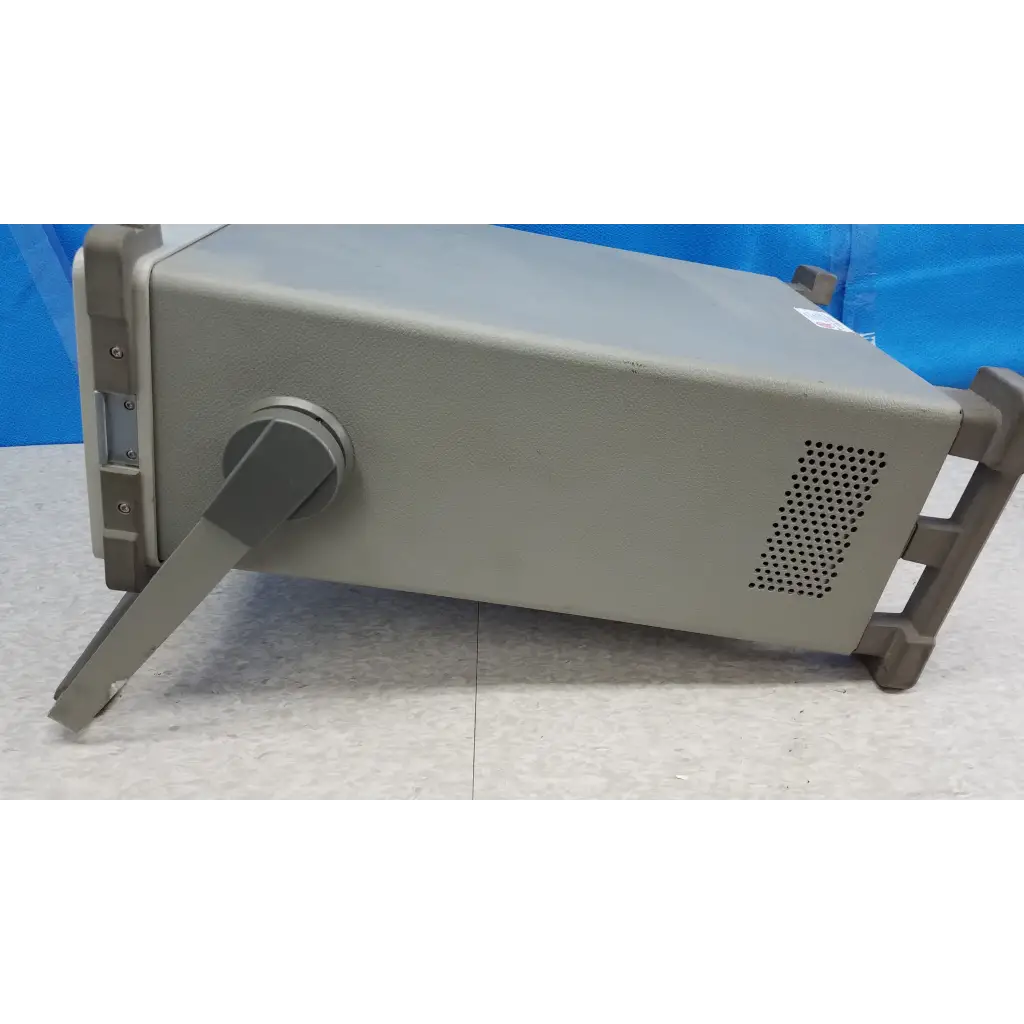 Gray metallic hewlett packard 8920a communications test set with handle and ventilation panel for rf testing