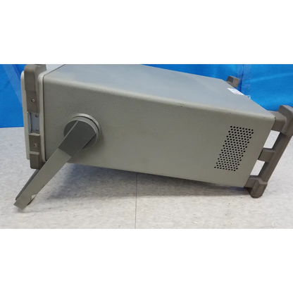Gray metallic hewlett packard 8920a communications test set with handle and ventilation panel for rf testing