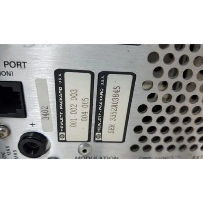 Silver metallic hewlett packard 8920a communications test set with black serial and model label stickers visible