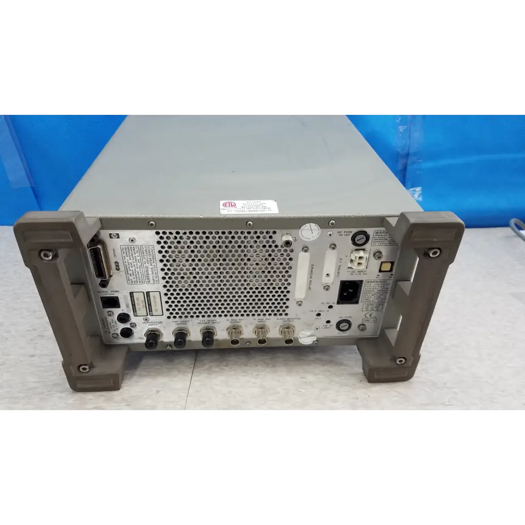 Gray metal rack-mountable hewlett packard 8920a communications test set back panel with multiple ports and perforations