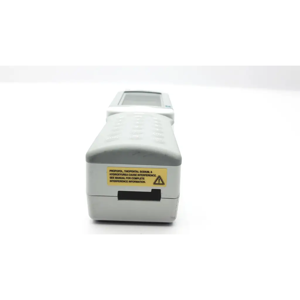 Gray i-stat 1 analyzer blood hematology device with small screen keypad and yellow warning label portable use