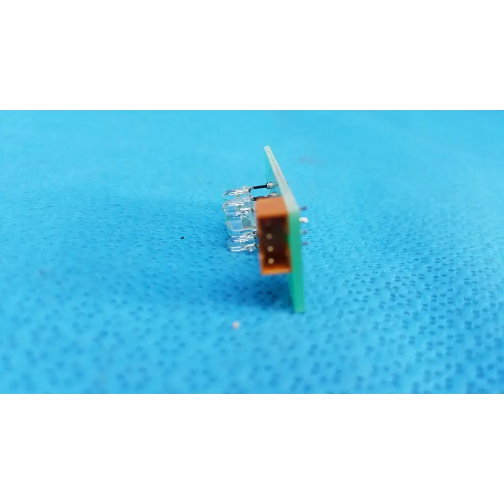 Green circuit board with orange and clear plastic components for internal led illumination in Topcon retinal camera