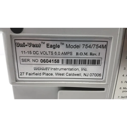 White plastic label on impact instrumentation uni-vent 754 portable ventilator showing model and manufacturer details