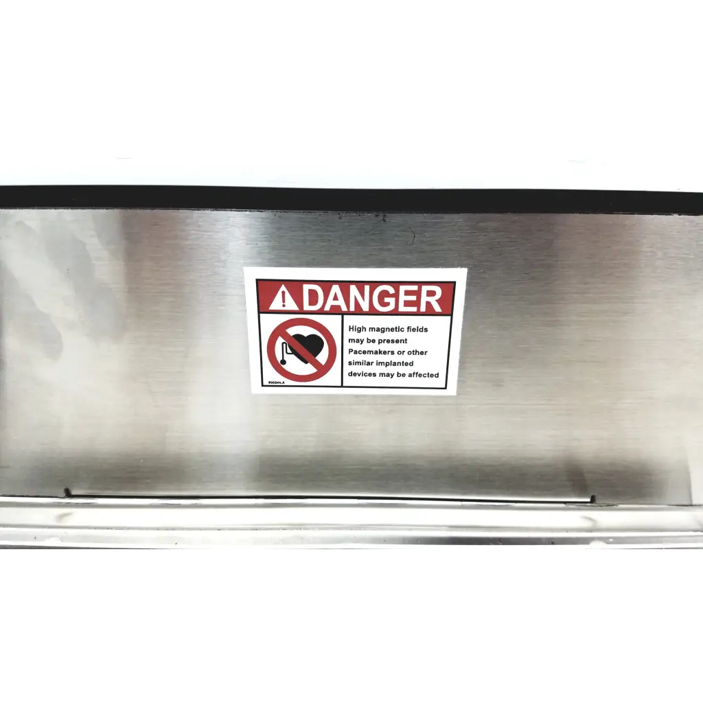 Warning label with red danger header and heart icon on brushed stainless steel industrial magnetics imi demagnetizer
