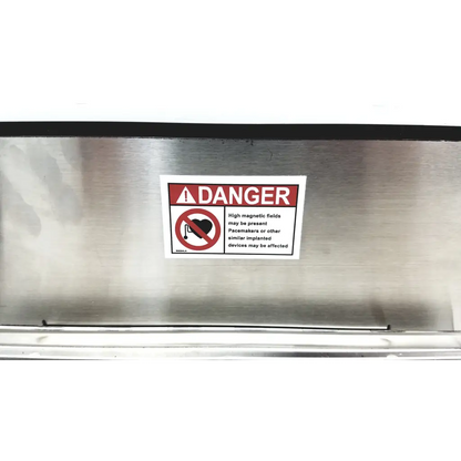 Warning label with red danger header and heart icon on brushed stainless steel industrial magnetics imi demagnetizer