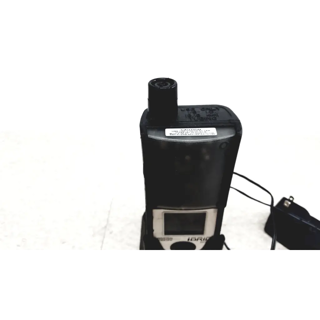 Black plastic industrial scientific ibrid mx6 multi gas monitor with small screen and cylindrical sensor on top with charger