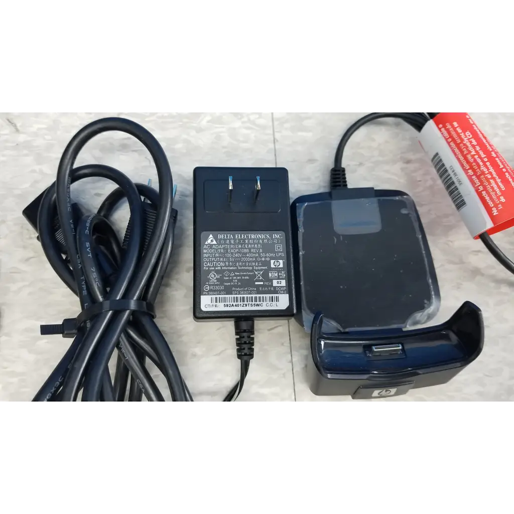 Black plastic delta electronics ac adapter with coiled cord and blue phone dock in innov-x systems analyzer spectrometer kit
