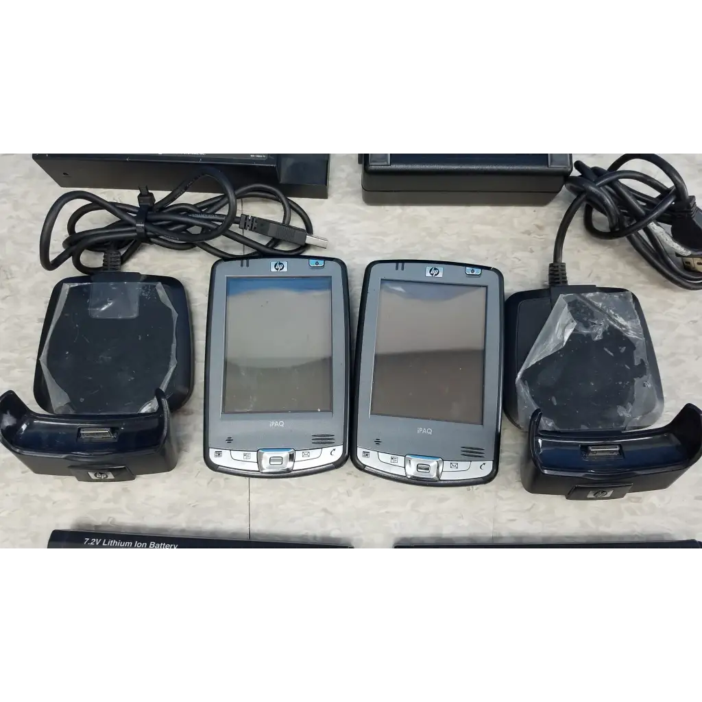 Two silver hp ipaq handheld devices with black charging docks in innov-x systems a-4000 s alpha handheld analyzer spectrometer kit