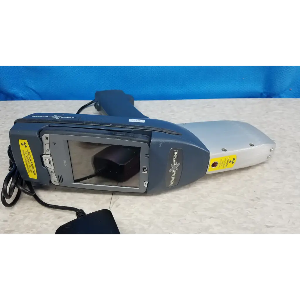 Gray and silver handheld innov-x systems a-4000 s alpha analyzer spectrometer kit with screen buttons and warning labels
