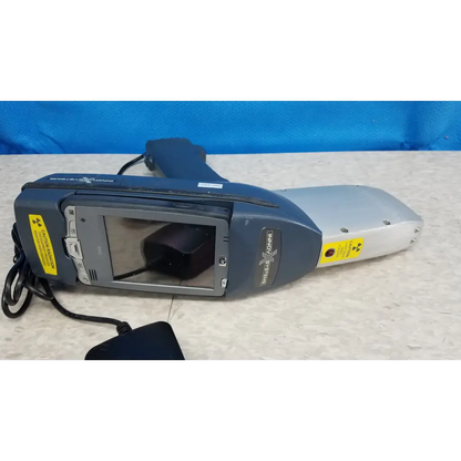 Gray and silver handheld innov-x systems a-4000 s alpha analyzer spectrometer kit with screen buttons and warning labels