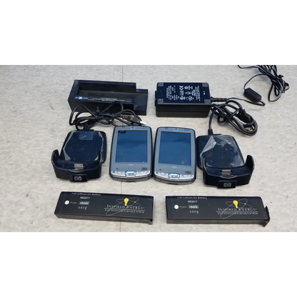 Two silver hp ipaq handhelds with black docks and batteries in the innov-x systems a-4000 s alpha handheld analyzer spectrometer kit