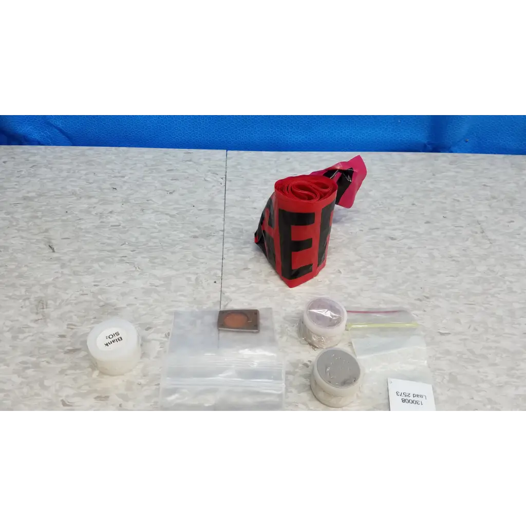 Red and black striped reflective safety tape with pink tab in innov-x systems a-4000 s alpha handheld analyzer spectrometer kit