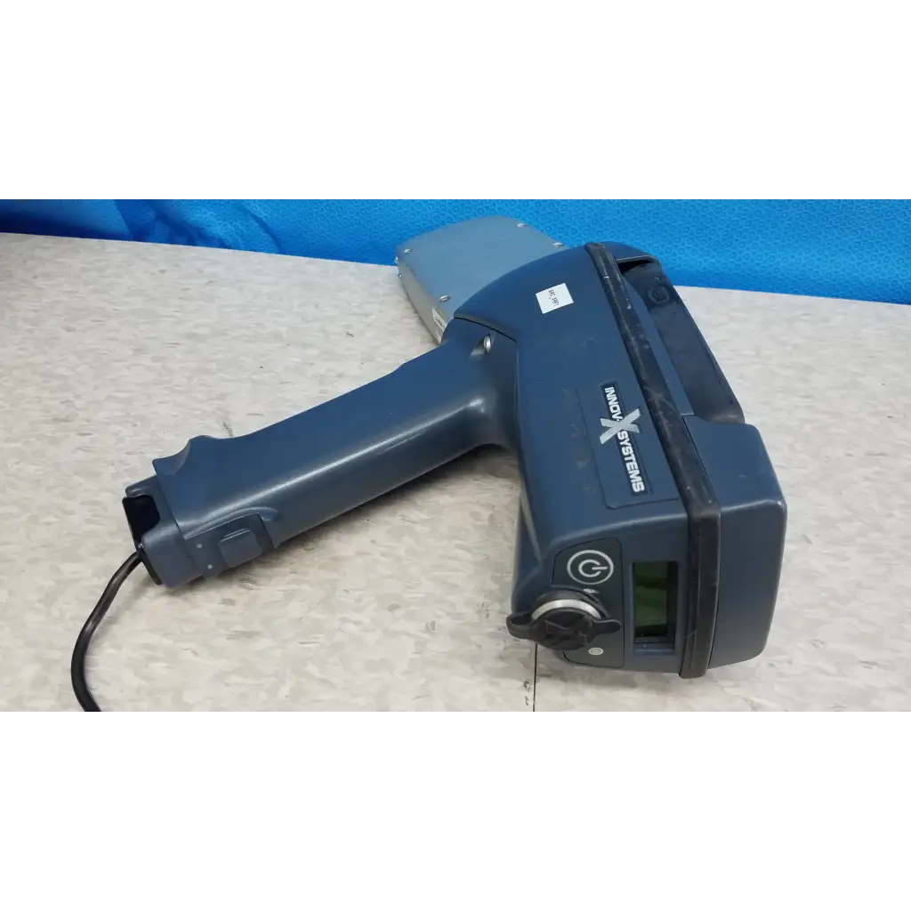 Dark blue handheld innov-x systems analyzer spectrometer with gray sensor head and black cord in spectrometer kit