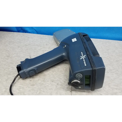 Dark blue handheld innov-x systems analyzer spectrometer with gray sensor head and black cord in spectrometer kit