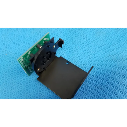 Black plastic and metal mounting bracket with green circuit board for internal fixation target in topcon trc-nw6s retinal camera