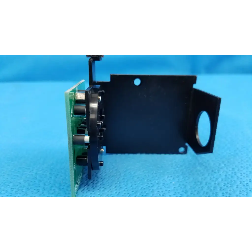 Black plastic and green circuit board assembly with black cylindrical components for internal fixation target use in topcon retinal camera