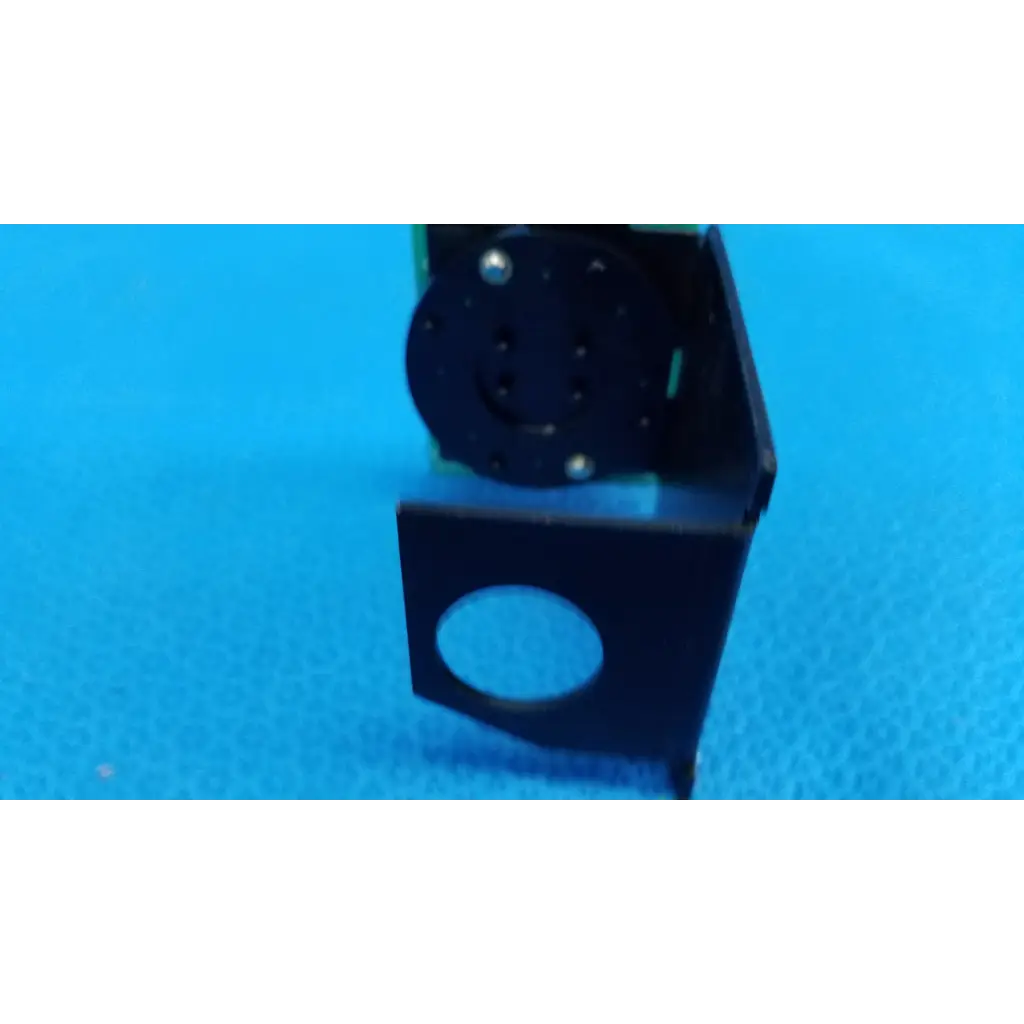 Black plastic internal fixation target circuit board with circular cutout and screw holes for topcon retinal camera