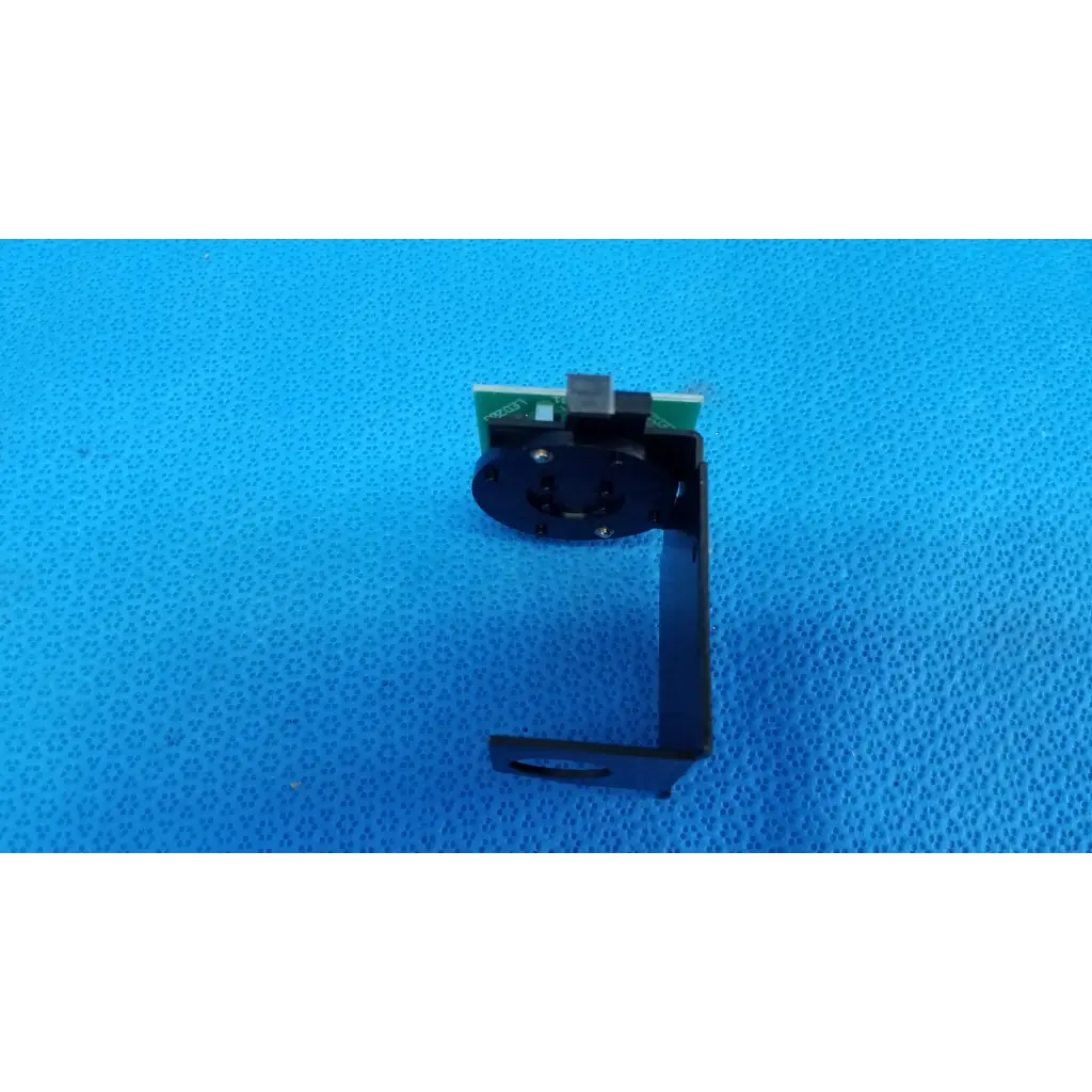 Black metal camera mount with green circuit board for internal fixation target on topcon trc-nw6s retinal camera