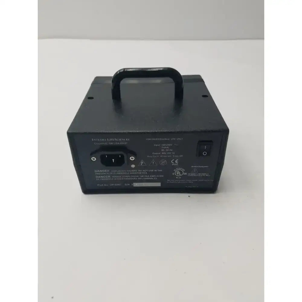Black rectangular electric dermatome power supply with top handle and labeled specifications on back panel of integra padgett model s