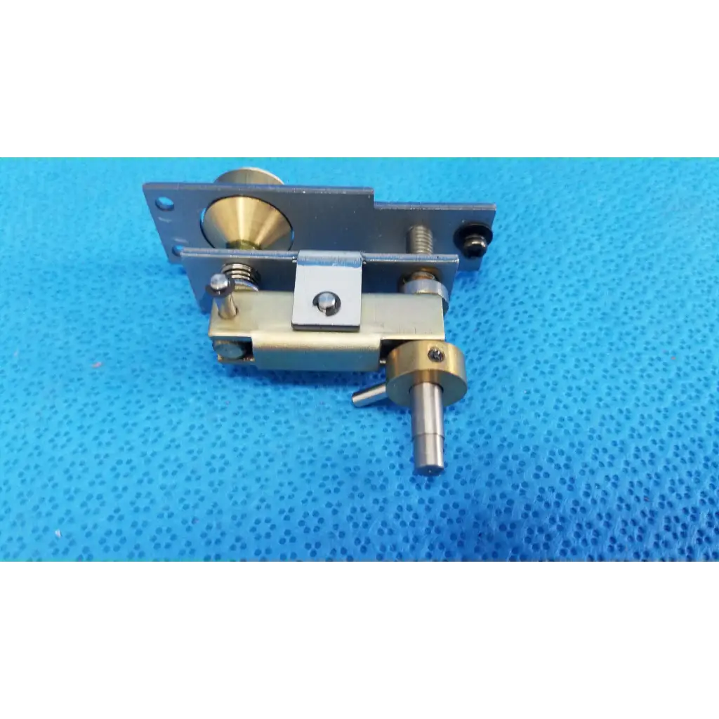 Metallic mechanical assembly with brass and silver-toned plunger pin and adjustment screws for topcon main unit