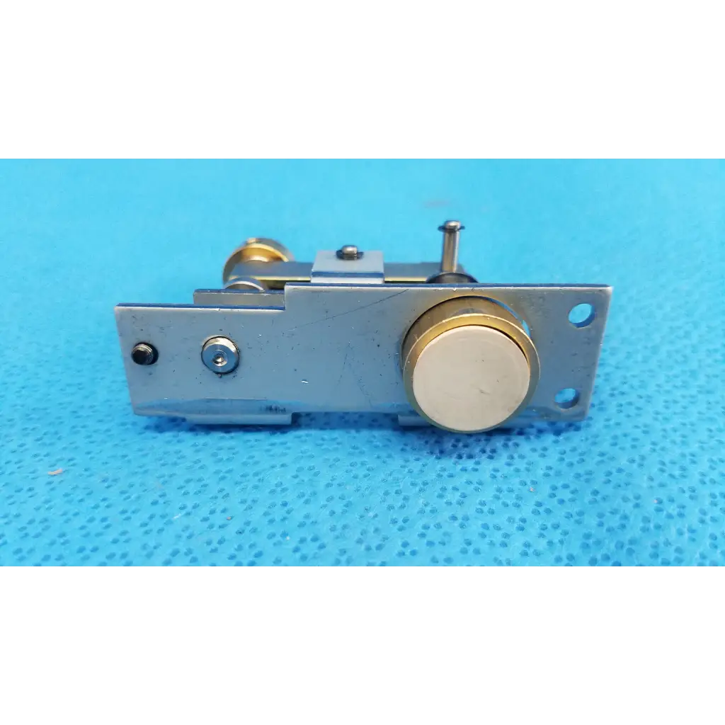 Silver metal door latch with gold-toned accents and circular knob for main unit plunger pin mechanical assembly