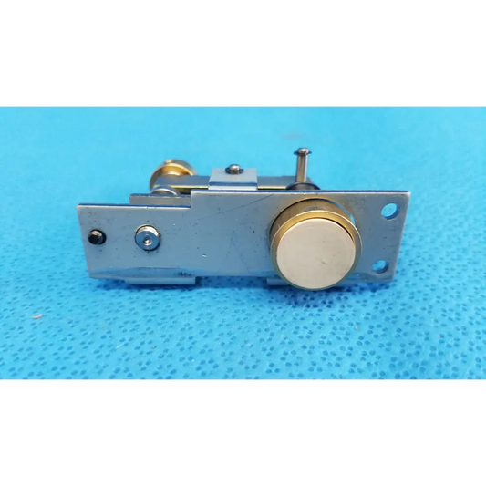 Silver metal door latch with gold-toned accents and circular knob for main unit plunger pin mechanical assembly