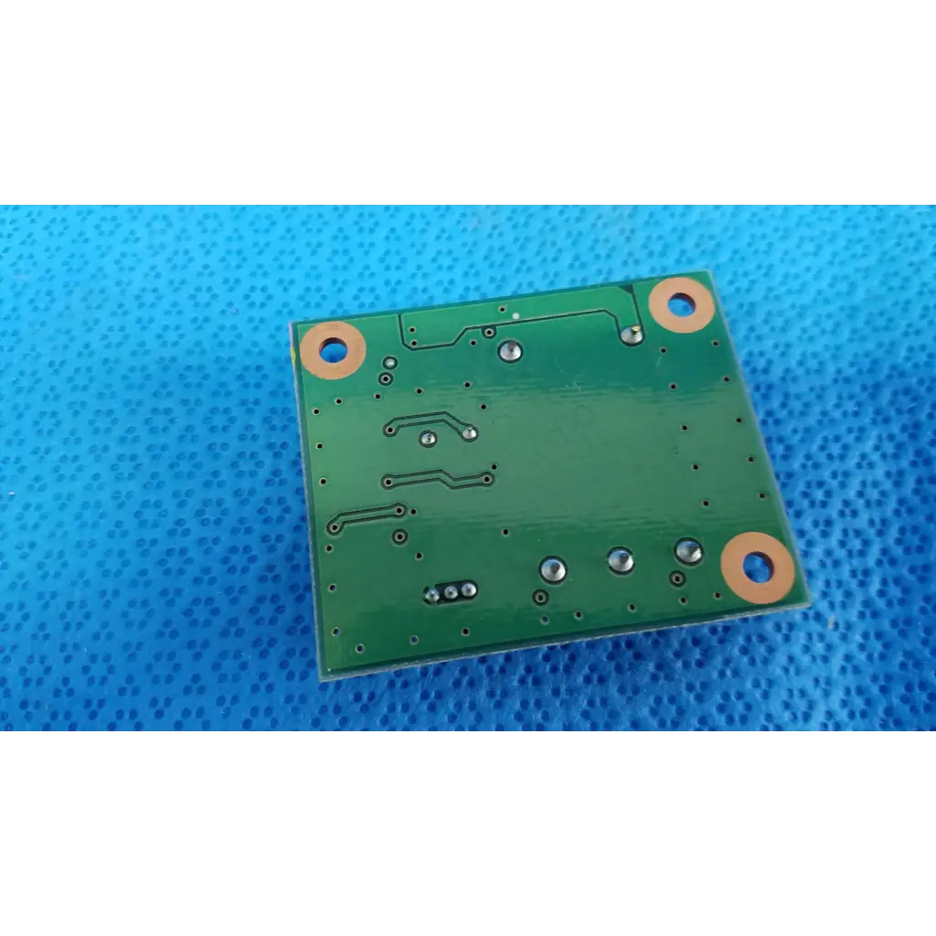 Green rectangular internal blink control circuit board with copper traces and mounting holes for Topcon TRC-NW8 camera