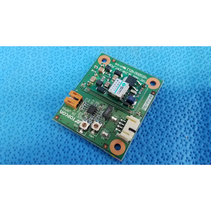 Green rectangular blink control circuit board with electronic components and orange mounting holes for Topcon TRC-NW8 camera