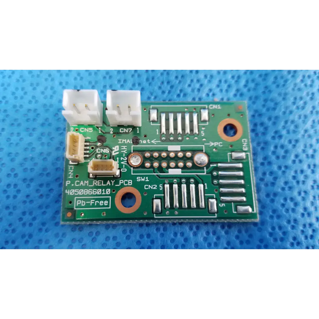 Green rectangular internal camera relay connection pcb board with white connectors labeled p.cam_relay_pcb pb-free