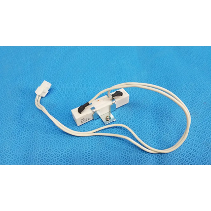 White plastic and metal thermal fuse with black lever and white wire for ceramic power resistor in fundus retinal camera