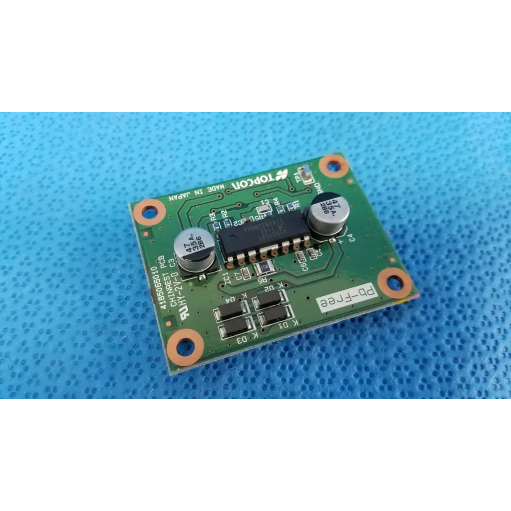 Green rectangular motor driver pcb with black integrated circuits and orange mounting holes for chinrest motor use