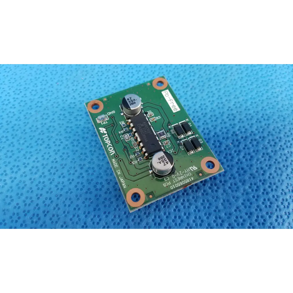 Green printed circuit board with black integrated circuits and silver capacitors for topcon chinrest motor driver pcb