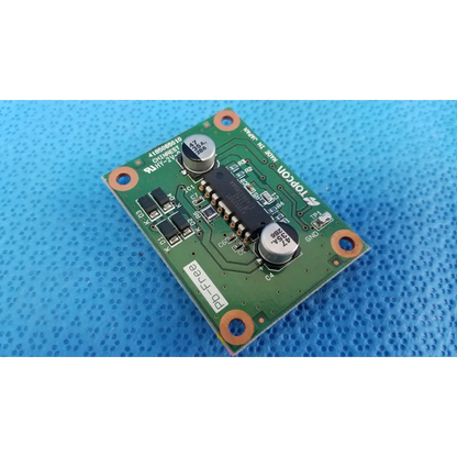 Green printed circuit board with silver capacitors and black integrated circuits featuring topcon branding for chinrest motor driver pcb