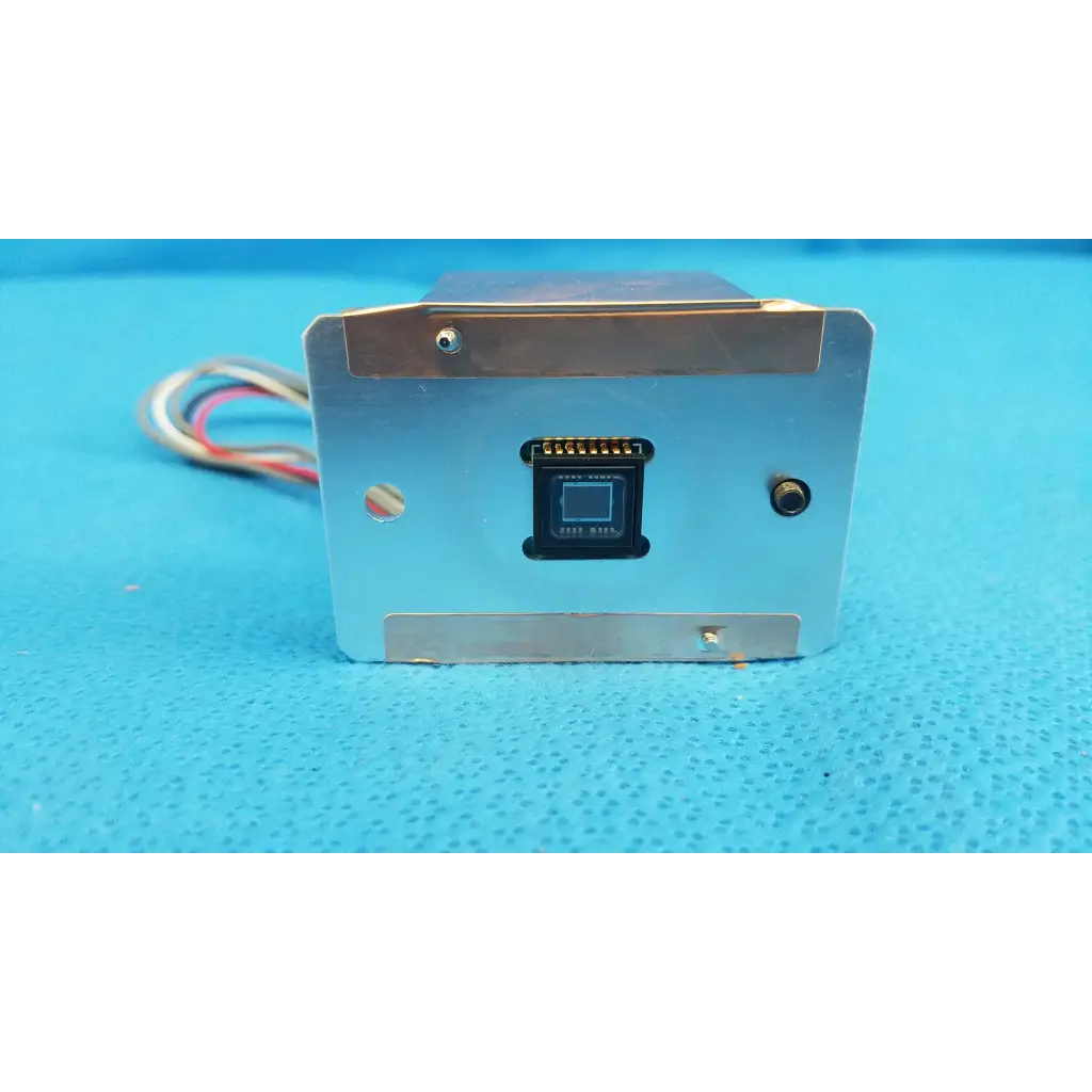 Silver metallic rectangular ccd sensor module with black component and multicolored wires for imaging alignment in retinal camera