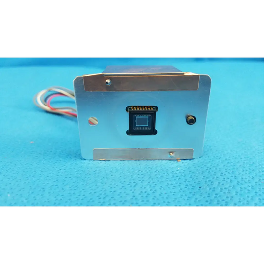 Silver metallic rectangular ccd sensor module with black component and multicolored wires for imaging alignment in retinal camera