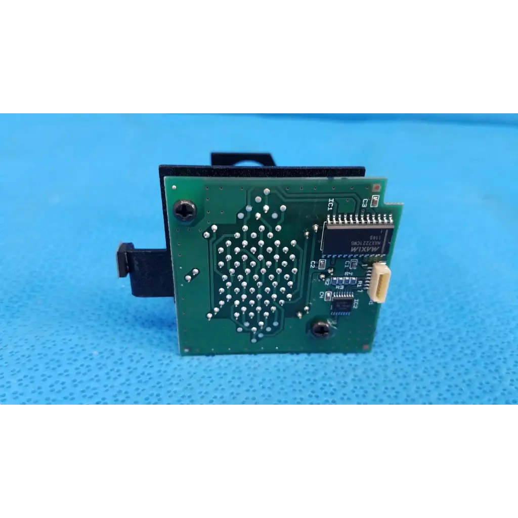 Green printed circuit board with black components and silver solder points for internal lcd dot matrix fixation target board