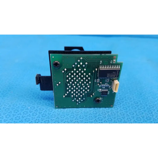 Green printed circuit board with black components and silver solder points for internal lcd dot matrix fixation target board