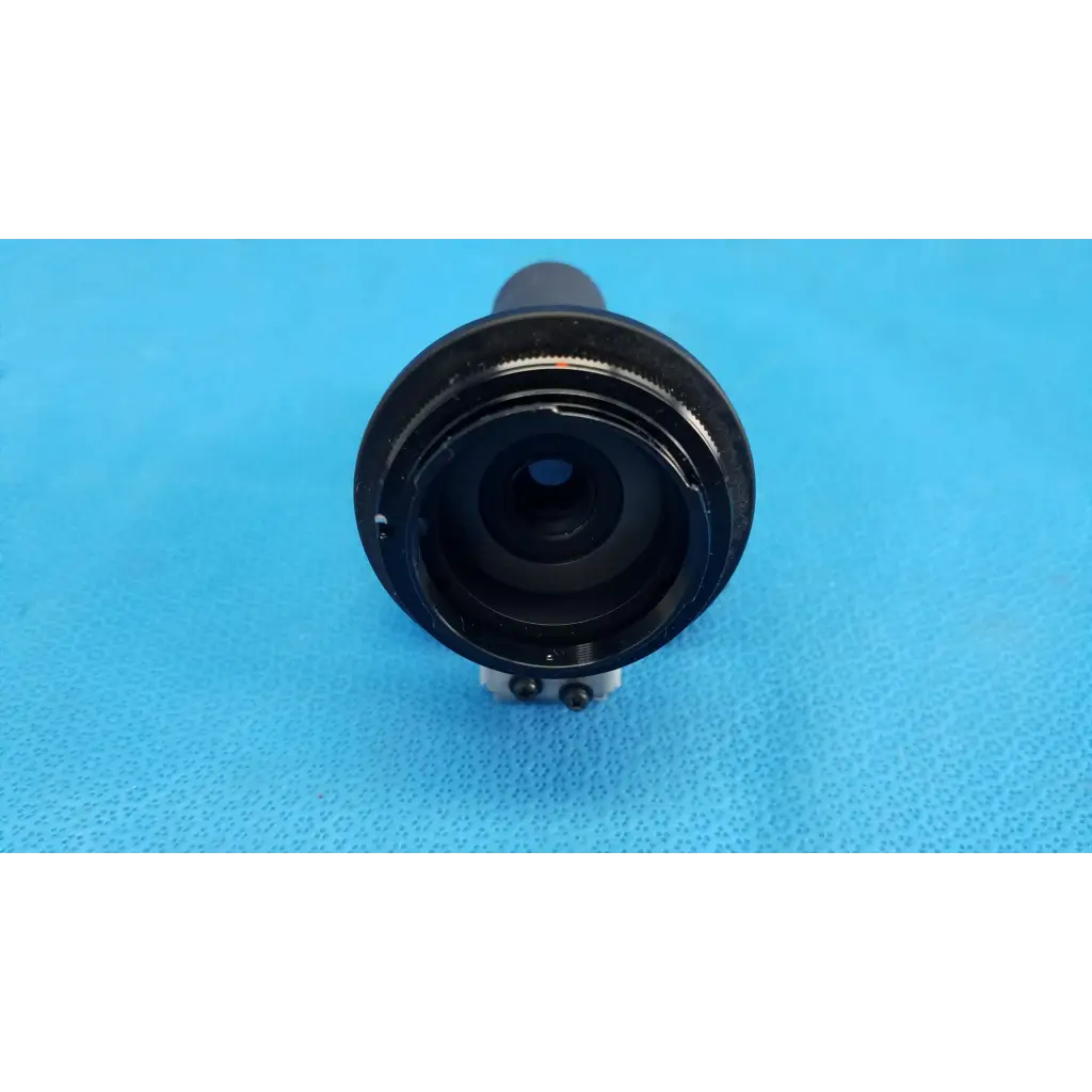 Black cylindrical main optical lens barrel with metallic ring and visible internal glass for topcon retinal camera