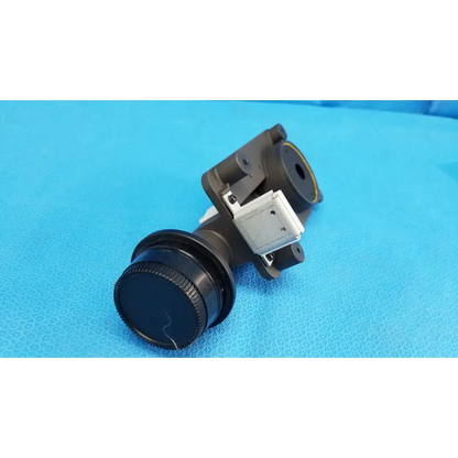 Black lens barrel with textured focus drive and porro prism mounted on adapter ring for topcon trc-nw8 camera