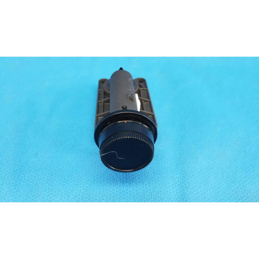 Black cylindrical flashlight with textured grip and matte finish used as focus drive for porro prism lens barrel assembly