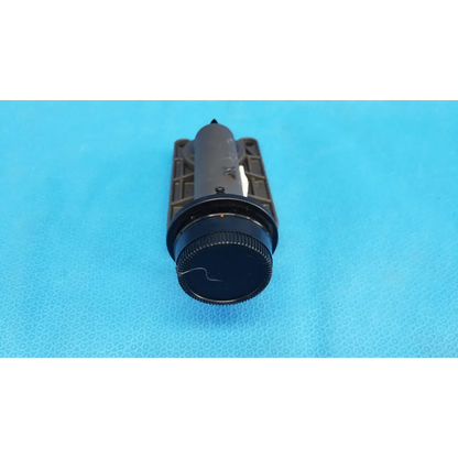 Black cylindrical flashlight with textured grip and matte finish used as focus drive for porro prism lens barrel assembly